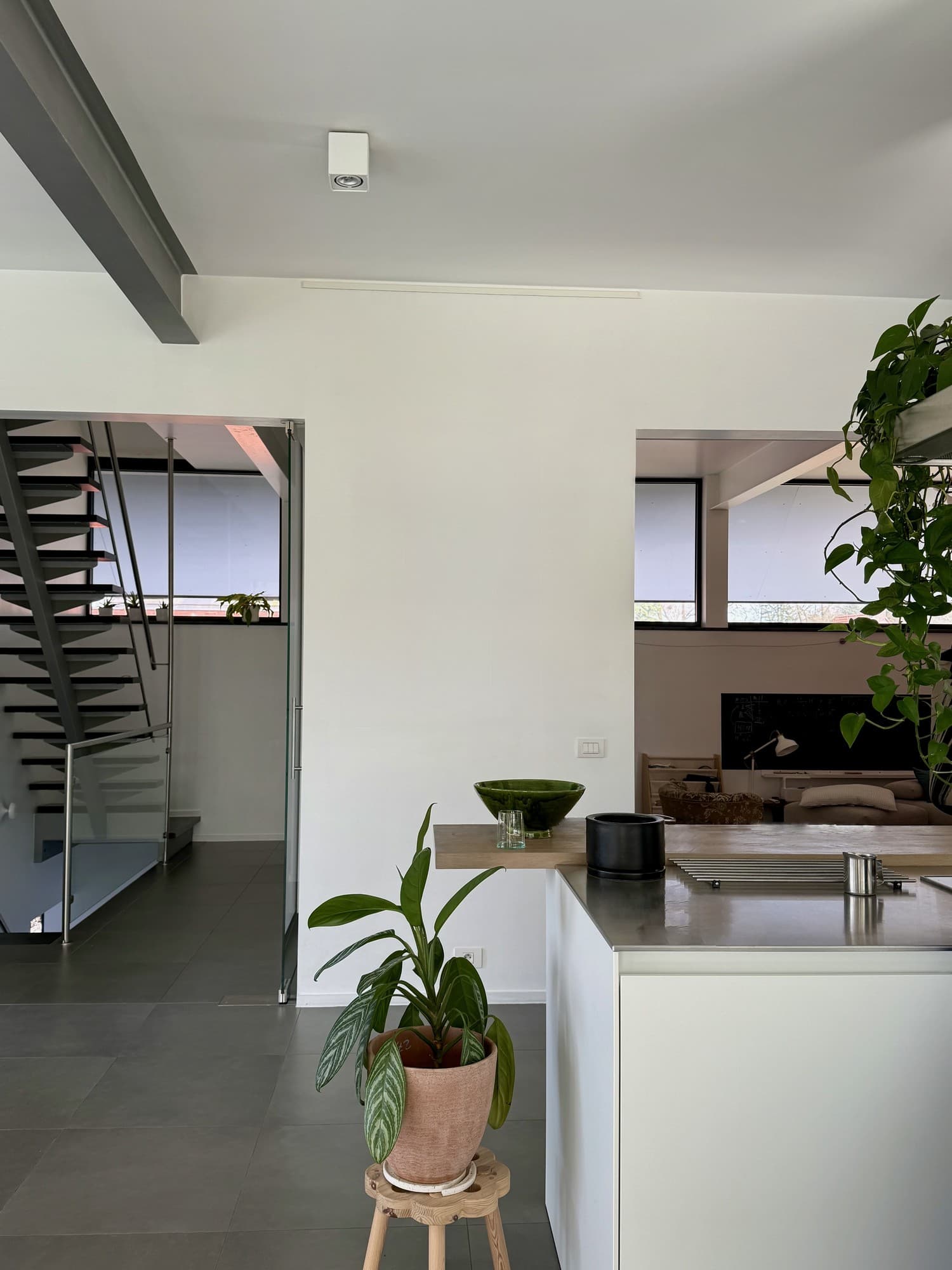 The living space with an empty wall beside the kitchen